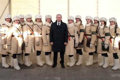 Vladimir Putin flanked by stunning women in Red Army uniforms as he ...