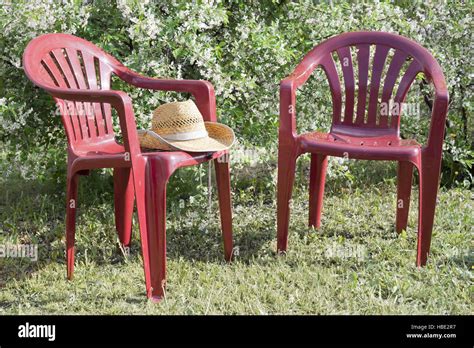 Plastic chairs in the garden Stock Photo - Alamy