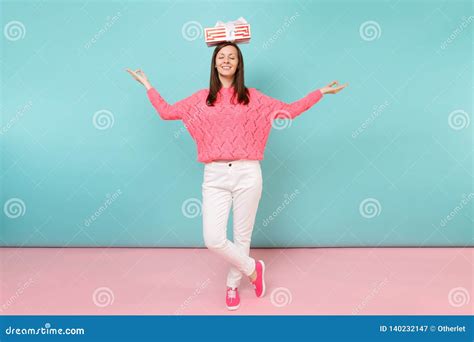 Full Length Portrait Of Woman In Knitted Rose Sweater White Pants