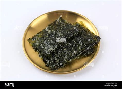 Roasted Nori Laver Seaweed On Golden Plate Isolated On White Stock