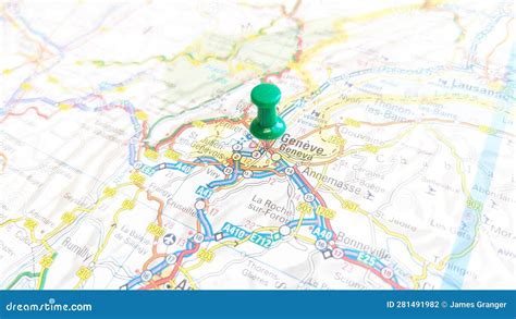 A Green Pin Stuck In Geneva On A Map Of Switzerland Editorial