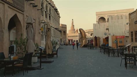 Souq Waqif Main Street At Sunset Showing Coffee Shops People Walking