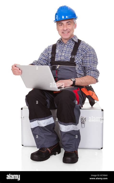 Mature Technician Holding Laptop Over White Background Stock Photo Alamy