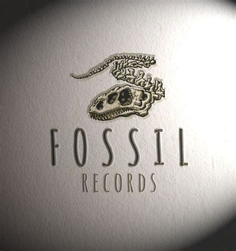 the fossil records logo is seen through a magnifying glass, which shows an image of a dinosaur's ...