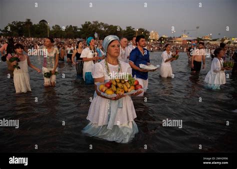 A Woman Enters The Sea With An Offering For The African Sea Goddess