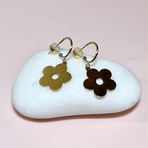 Gold daisy half hoops / Penny Foggo