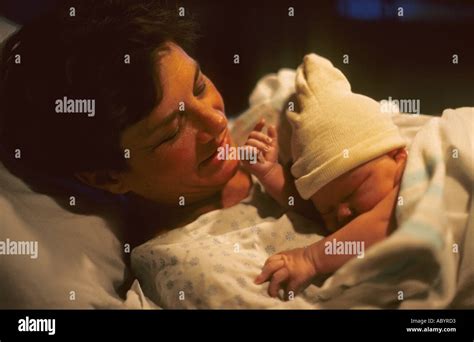 Newborn Baby In Arms Of Mother Stock Photo Alamy