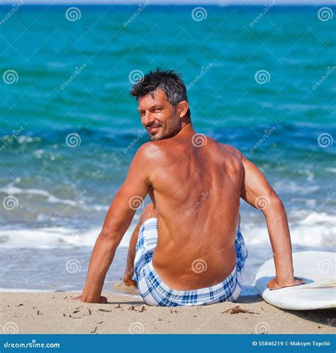 Man With His Surfboard On The Beach Stock Image Image Of Sand