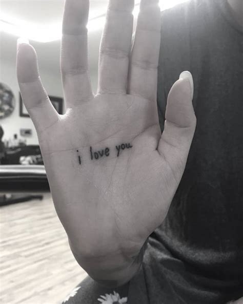 "I love you" lettering tattoo on Julia Michael's palm.