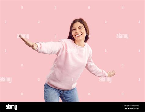 Happy Fashion Model In Pink Sweatshirt Smiling And Posing On Pink