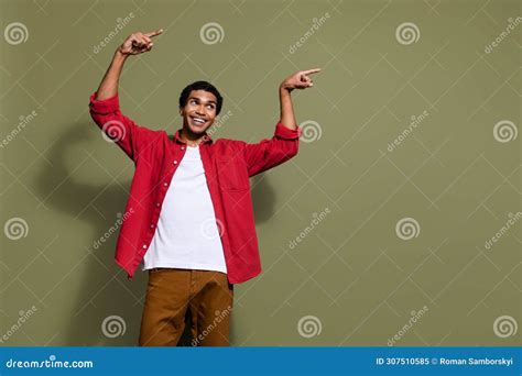 Photo Of Cheerful Excited Man Dressed Red Shirt Looking Pointing Two Fingers Empty Space