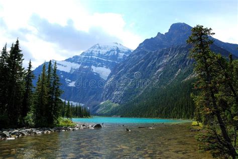 Lake in Rockies stock image. Image of snow, stone, green - 4326405