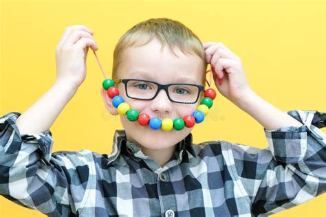 Development Of Fine Motor Skills Toddler Boy Is Stringing Beads On A