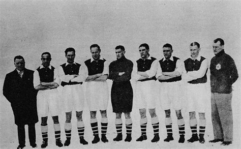 A Group Of Men Standing Next To Each Other In Front Of A White Table Cloth