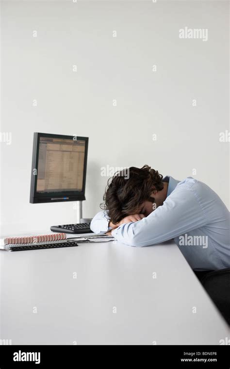 Business Man Resting Head On Office Desk Side View Stock Photo Alamy