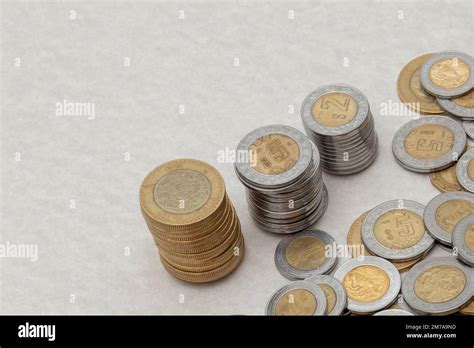 stack of mexican peso coins of various denominations, with copy space ...