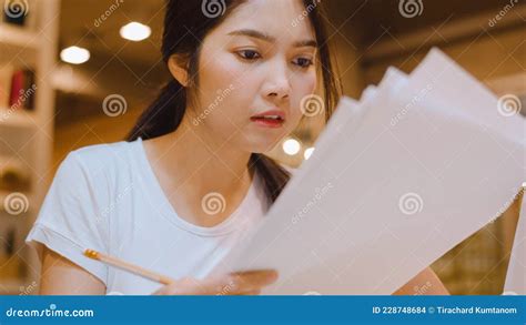 Asian Student Women Reading Books In Library At University Young