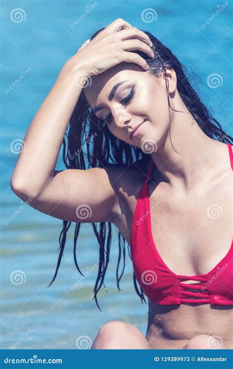 Portrait Of A Beautiful Woman In Red Bikini On The Beach Stock Image