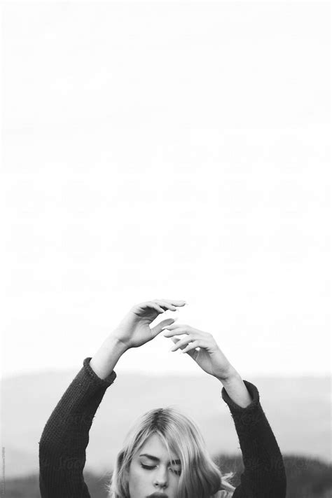 Beautiful Blonde Woman With Eyes Closed Raises Her Arms To The Sky By Stocksy Contributor