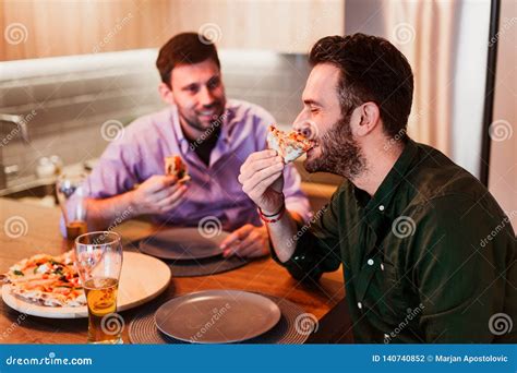 Two Guys Eating Pizza At Home Stock Photo Image Of Handsome Indoor