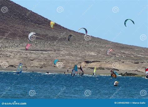 Fans Practicing Kitesurfing On The Red Mountain Volcanic Sand Beach Of