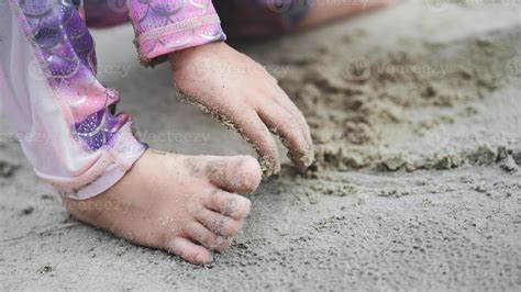 Close Up portrait of kids feet and hand playing with sand. Sensory ...