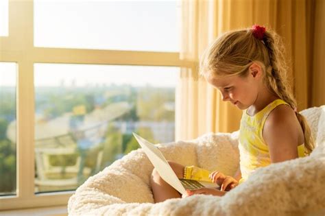 Premium Photo Child Using Laptop At Home