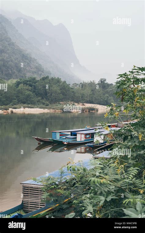 Traditional Laotian Wooden Slow Boat On Nam Ou River Near Nong Khiaw