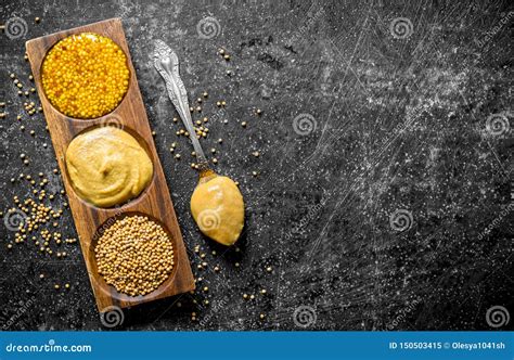 Assortment Of Different Types Of Mustard With A Spoon Stock Image