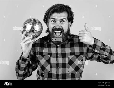 Happy Man Celebrating Party With Disco Ball And Showing Thumb Up Lets