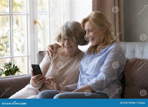 Happy Mature Woman Hugging Cheerful Old Mom Using Smartphone Stock Photo Image Of Love