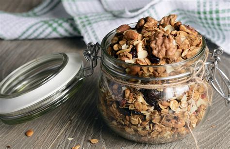 Homemade Granola In Open Glass Jar On Rustic Wooden Background First