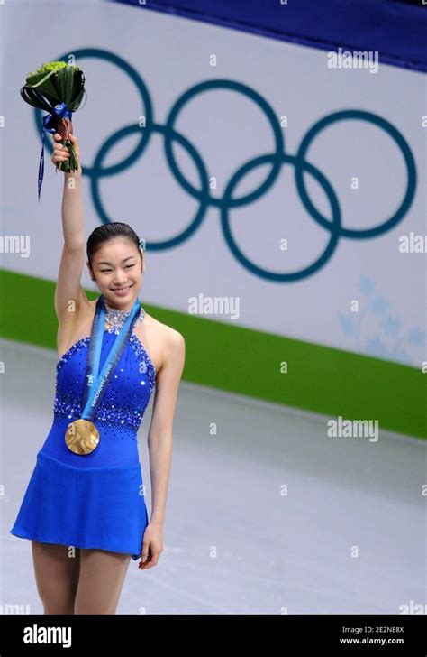 Kim Yu Na Of South Korea Receives The Gold Medal During The Medal Ceremony For The Ladies Free