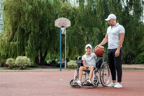 Premium Photo Dad Plays With His Disabled Son On The Sports Ground