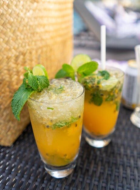 Premium Photo Tropical Cocktail With Passion Fruit Lime And Mint On