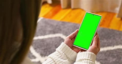 Back View Of Brunette Holding Smartphone With Green Screen Watching Content Stock Video Video