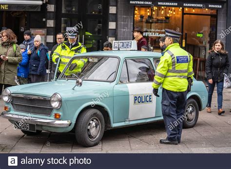 Policemans standing by his police car.Police sign on an Austin patrol car.AUSTIN1300 Police ...