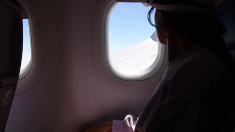 Jordan Woman Looks Out The Window Of An Flying Airplane Wings