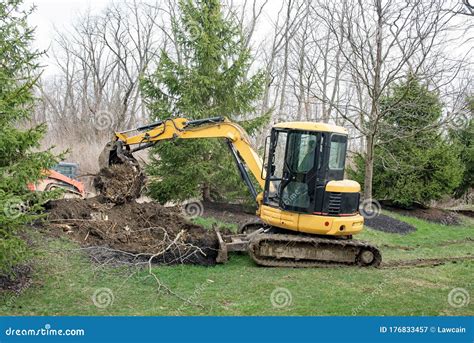 Backhoe Digging Soil At Construction Site. Bucket Of Backhoe Digging ...