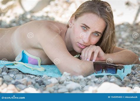 Beautiful Woman In Bikini Resting On Pebble Beach Stock Image Image