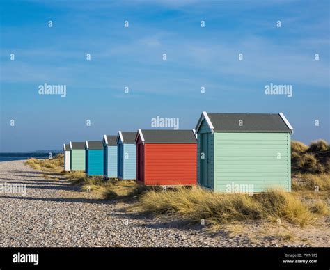 Brightly Coloured Beach Huts At Findhorn Beach Moray Scotland Stock