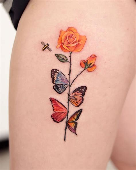 An Orange Rose And Butterflies Tattoo On The Thigh