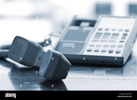 Telephone handset off the hook on desk Stock Photo - Alamy
