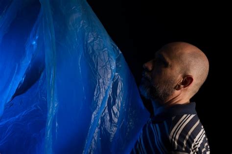 Premium Photo Mature Man With A Transparent Plastic Blue Bag Flying