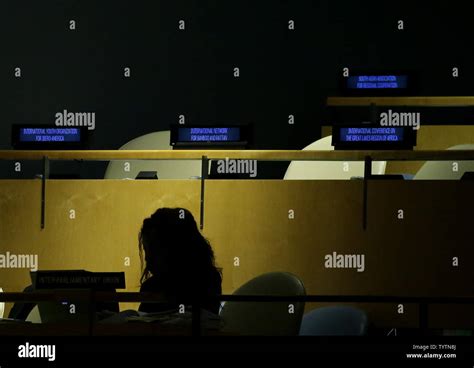 An Attendee Sits With Empty Chairs Behind Her As Speakers Continue Do