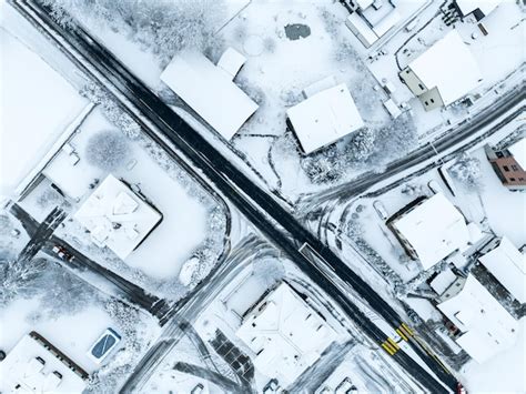 Premium Photo | Aerial view of town with snow covered houses. roof tops ...