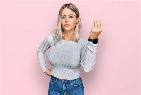 Premium Photo Beautiful Blonde Woman Wearing Casual Clothes Doing Italian Gesture With Hand