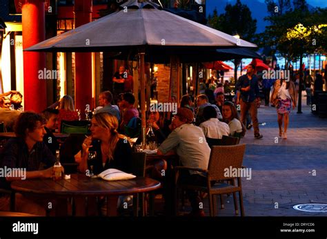 Visitors enjoy the nightlife in Queenstown, New Zealand Stock Photo ...