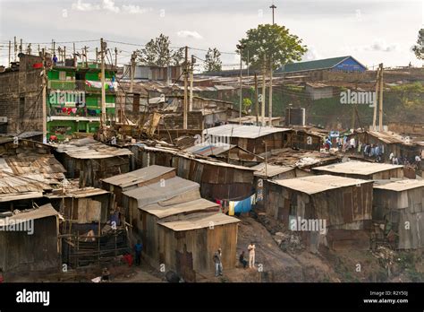 Corrugated Metal Shacks And Buildings With People Outside Them In