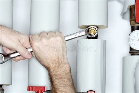 Worker is Fixing a Pipe with Wrench Stock Image - Image of basement ...